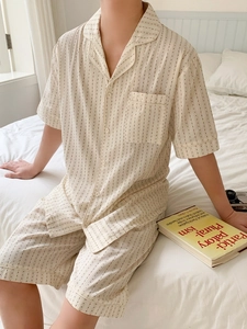 Close-up of lightweight striped pajama set featuring notch collar and polka dot pattern