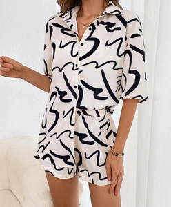Detail of summer two-piece set with abstract print on short-sleeve shirt and shorts