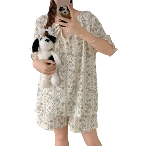 Women's floral cotton pajama set featuring drawstring short sleeves and matching shorts