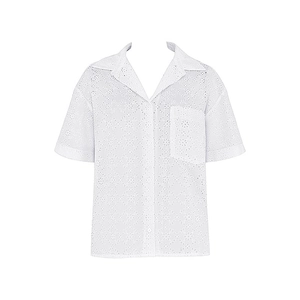 Close-up of white short-sleeve shirt featuring intricate hollow embroidery and lapel