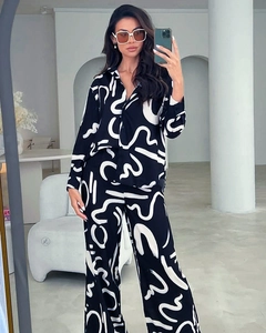 Detail of soft printed lounge set featuring abstract white patterns and button-down shirt