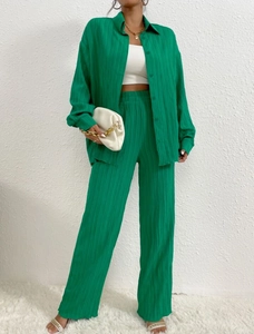 Detail showing the fine vertical pleated texture and green fabric of this two-piece set
