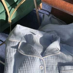 Detail of light blue gauze pajamas showing notch lapel and breathable cotton texture