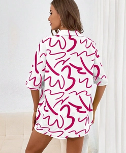 Detail view showing the loose fit and vibrant pink abstract print on the back of the shirt