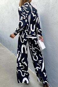 Rear view of black and white printed pajamas with wide-leg pants and loose shirt