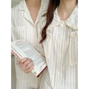 Matching striped couple pajamas with tassel detail and vintage button-down design