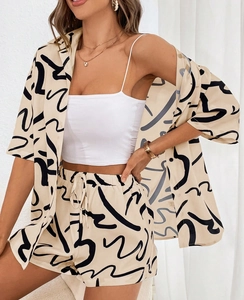 Detail of summer two-piece shirt set with abstract prints and drawstring shorts