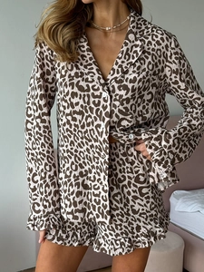 Detail of leopard print pajamas showing ruffled edges and button-down lounge set texture