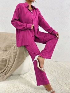 Close-up of pleated fabric texture on magenta long sleeve shirt and wide-leg trousers set