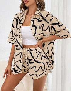 Detailed shot of casual two-piece set featuring abstract black print on beige fabric
