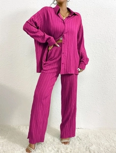 Detail of rose purple pleated fabric on long sleeve shirt and wide leg pants set