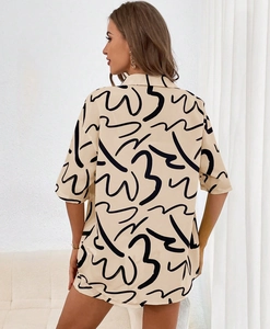 Detail view showing breathable abstract print fabric on a stylish casual shirt set
