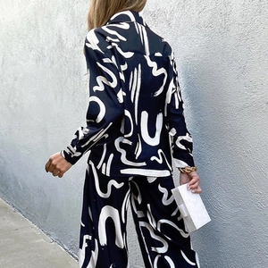 Women's pajama set with long sleeves and wide-leg pants in black and white abstract print