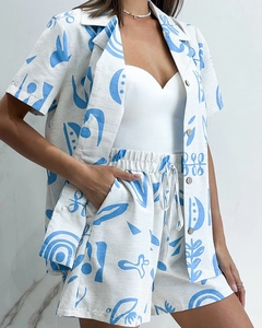 Detail of blue abstract print on linen fabric texture and wooden button closure