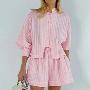 Close-up of pink jacquard shirt set showing vertical stripe texture and button details