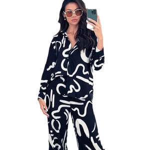 Women's black long sleeve pajama set with abstract white print and wide-leg trousers