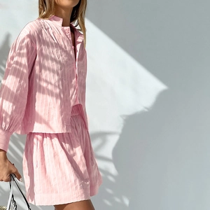 Detail of pink striped long-sleeve shirt and elastic shorts set with leaf shadow accents