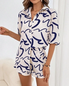 Detailed close-up of summer leisure set with abstract line print and button-up shirt