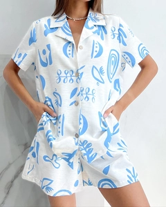 Detail of blue abstract print on white short-sleeve button-down pajama set for women