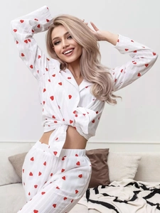 Detail view of white pajama set featuring heart print and soft textured fabric