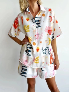 Detail of artistic mystical sun and moon print on white short sleeve shirt and shorts set