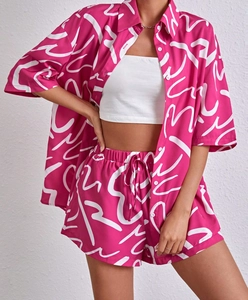 Detail of pink floral print casual set showing short sleeve shirt and drawstring shorts