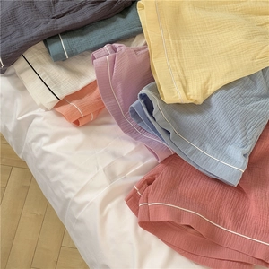 Detail of colorful cotton gauze lounge shorts with soft wrinkled texture and white piping