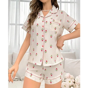 Close-up of waffle fabric pajamas with floral tulip print and pink piping detail