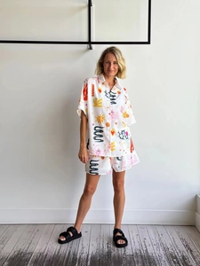 Detail view of bohemian style 2-piece set with colorful abstract sun and floral prints