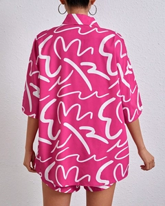 Back view of a rose pink two-piece set with white abstract print and short-sleeved shirt