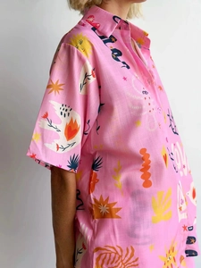 Detail of pink short-sleeve shirt with hand-drawn sun and love letter art prints