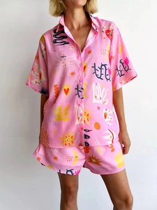 Detail of pink lounge set with colorful graffiti prints and short-sleeved collar shirt