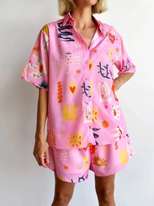 Detail of pink two-piece set featuring vibrant 3D graffiti snake and heart patterns