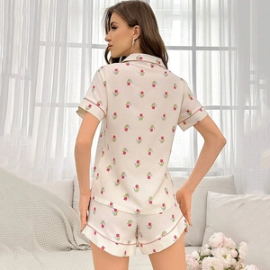 Detail view of floral pajama set featuring red tulip print and pink piping on back