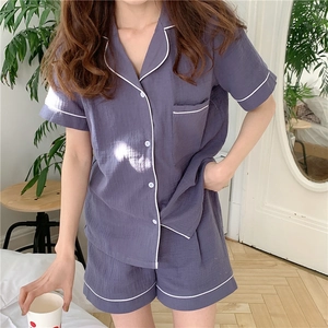 Detail of mauve gauze pajama set with white piping and breathable wrinkled texture