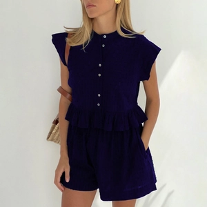 Women's summer navy blue two-piece set featuring peplum short sleeve shirt and wide-leg shorts