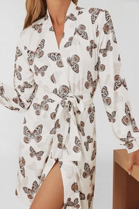 Close-up of lightweight robe featuring realistic butterfly prints and a waist tie belt