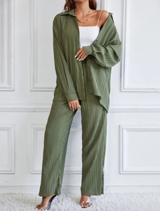 Detail of olive green pleated loungewear set featuring long sleeve shirt and wide leg trousers