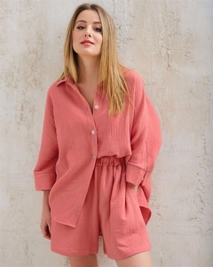 Detail of coral pink muslin cotton set showing natural crinkle texture and white buttons