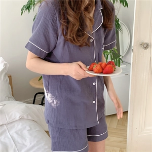 Close-up of lightweight purple gauze pajama set with white contrast piping details