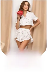 Detail of soft cotton pajama top with red heart pattern and front buttons