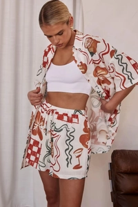 Detail of summer two-piece set featuring abstract digital print and drawstring shorts