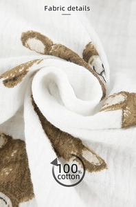Close-up of soft breathable white 100% cotton crepe fabric with brown bear pattern