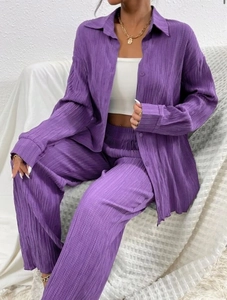 Detail of purple pleated two-piece set featuring vertical texture and relaxed silhouette