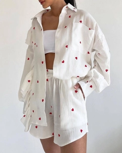 Detail of white cotton linen loungewear set with red heart print and ruffle trim