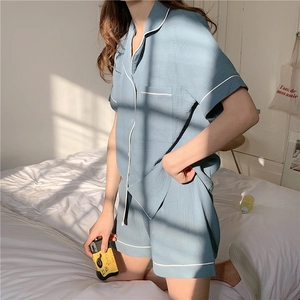 Detail of grey-blue short-sleeved cotton gauze pajamas set with white piping trim