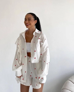Close-up of heart embroidery on white cotton-linen ruffle sleeve summer loungewear