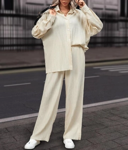 Detailed texture of beige pleated fabric on women's loose long sleeve shirt and pants set