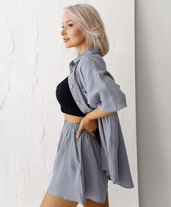 Detailed texture of light blue muslin cotton fabric on a loose summer pajama set