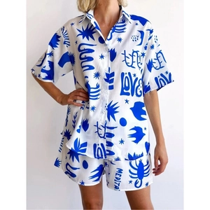 Women's two-piece summer set with blue geometric prints on a white short sleeve shirt and shorts